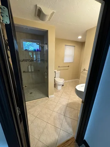 a kitchen with stainless steel appliances granite countertop a refrigerator a stove a sink and white cabinets