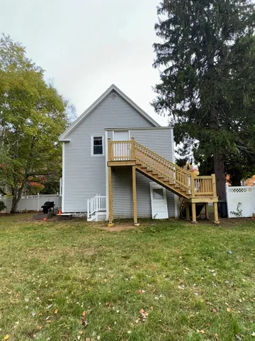 a view of a house with a yard porch and sitting area