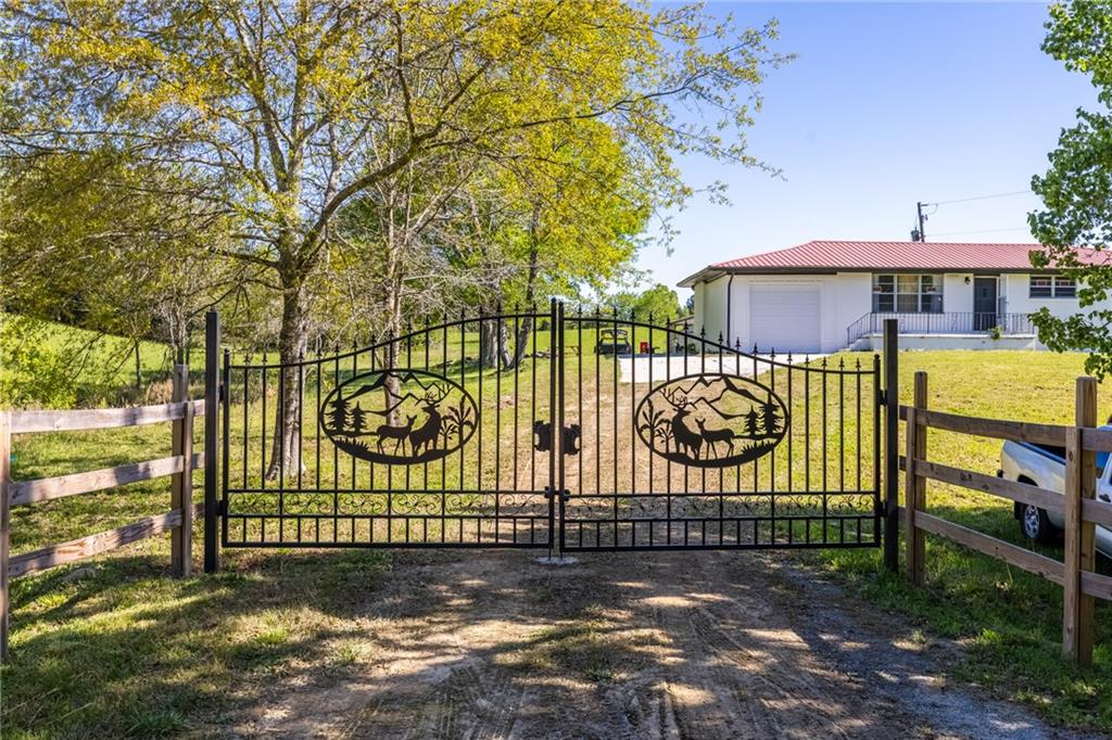 a view of a brick wall with a large trees