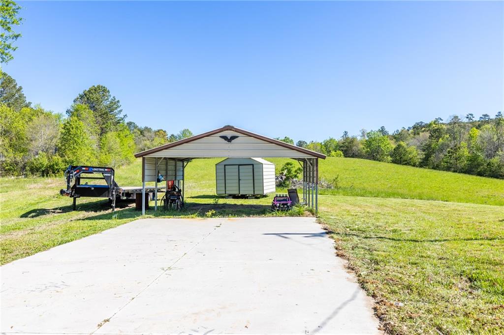 7596 Red Bud Road Northeast Ranger, GA 30734 - Photo 23 of 47 a view of a house with a yard and sitting area