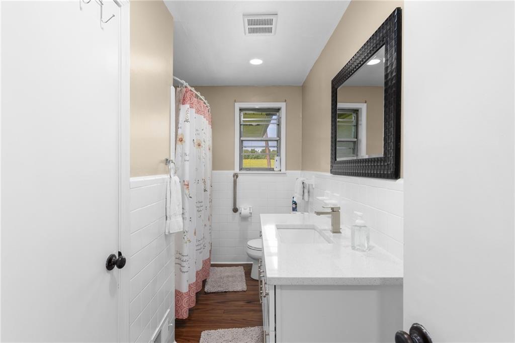 7596 Red Bud Road Northeast Ranger, GA 30734 - Photo 35 of 47 a bathroom with a sink a mirror and a shower