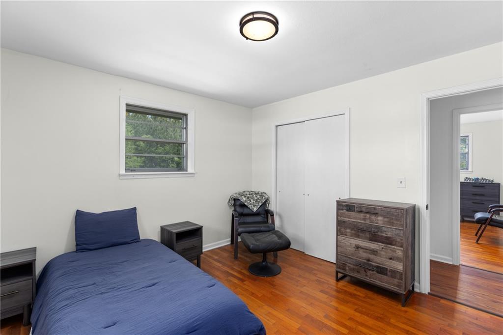 7596 Red Bud Road Northeast Ranger, GA 30734 - Photo 37 of 47 a bedroom with furniture and wooden floor
