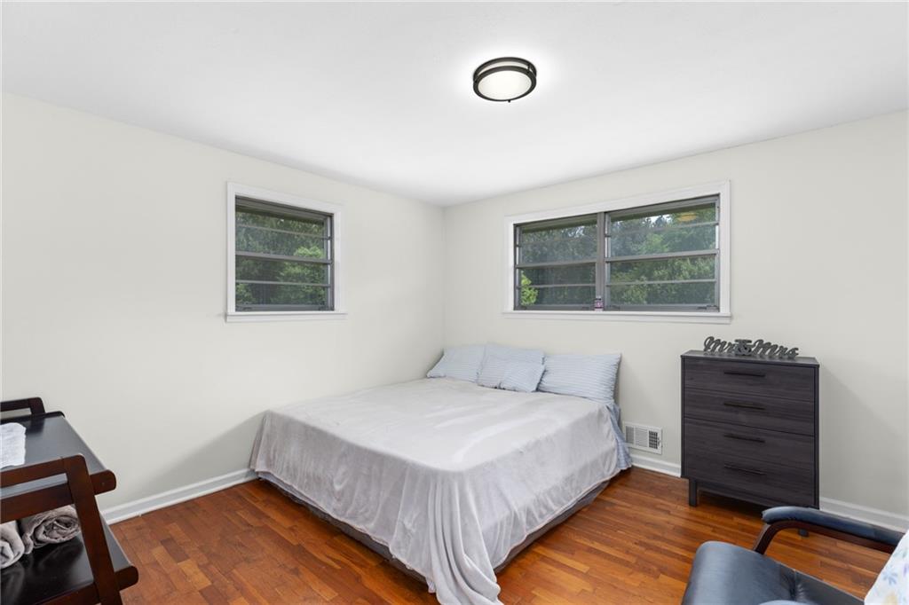 7596 Red Bud Road Northeast Ranger, GA 30734 - Photo 38 of 47 a bedroom with a bed and a dresser next to a window