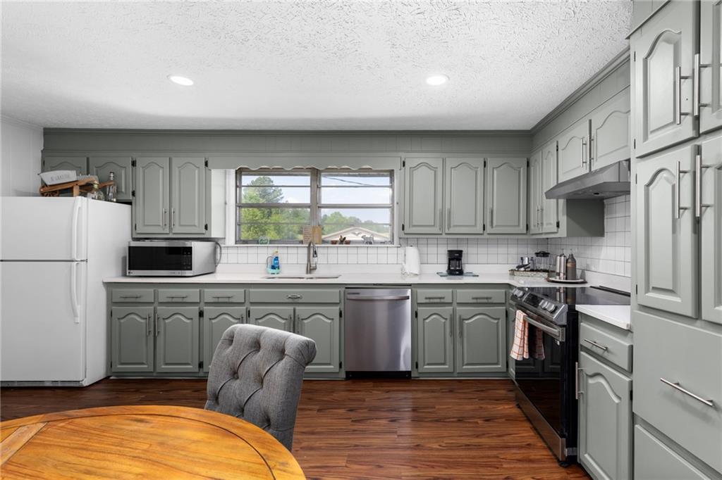 7596 Red Bud Road Northeast Ranger, GA 30734 - Photo 41 of 47 a kitchen with stainless steel appliances granite countertop a stove a sink dishwasher and a refrigerator