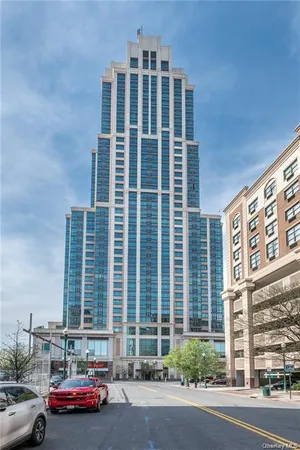 a front view of a building with car parked