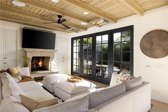 a living room with couches a fireplace and a large window with outer view