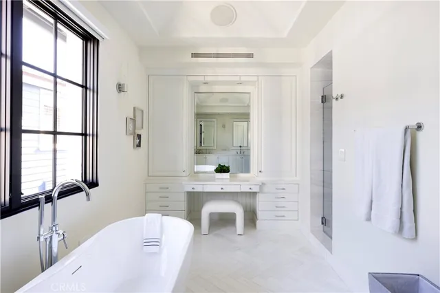 a spacious bathroom with a double vanity sink a mirror and a bathtub