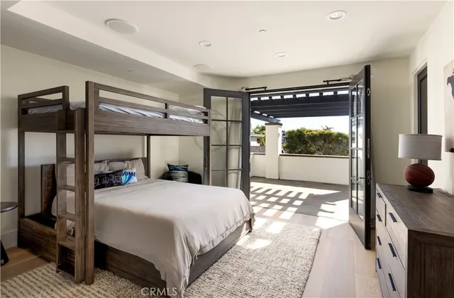 a bedroom with a bed and large window