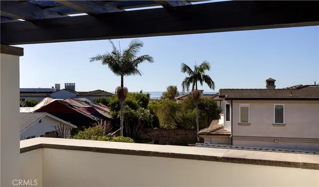 a view of a house with a balcony and a potted plant