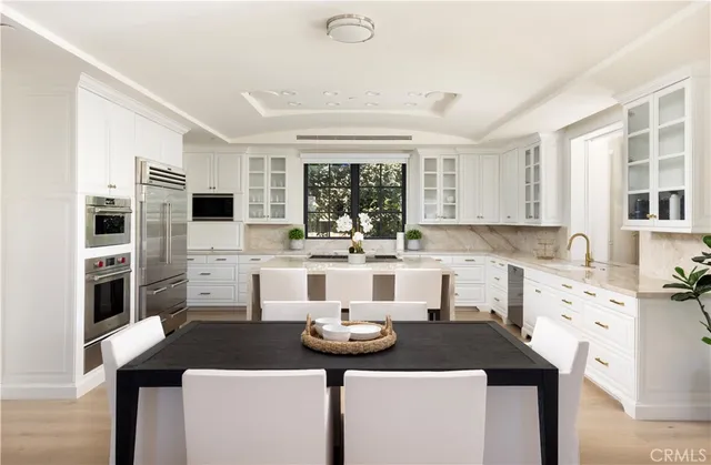 a kitchen with kitchen island granite countertop a sink and cabinets