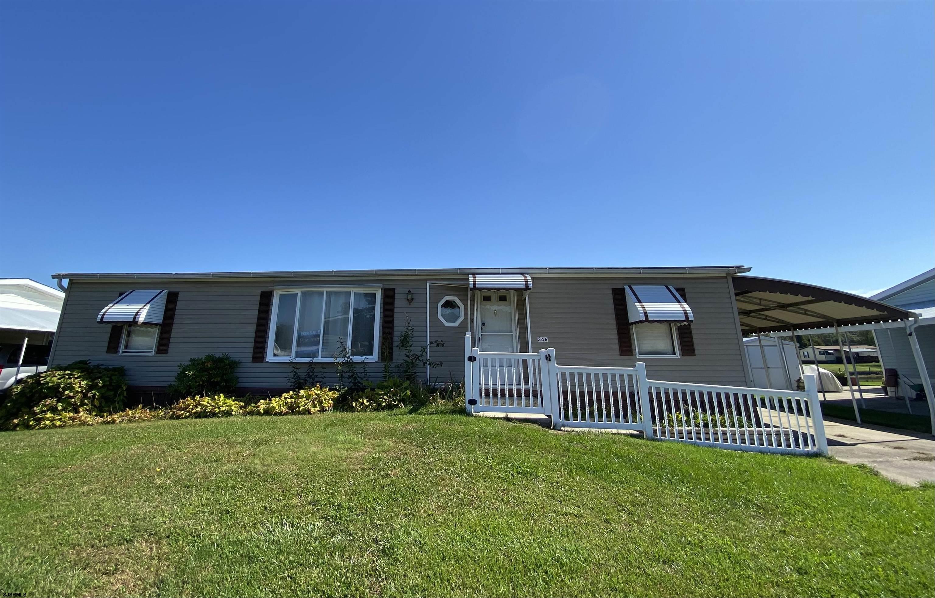 346 Puritan Drive Buena, NJ 08310 - Photo 1 of 22 a front view of a house with a garden