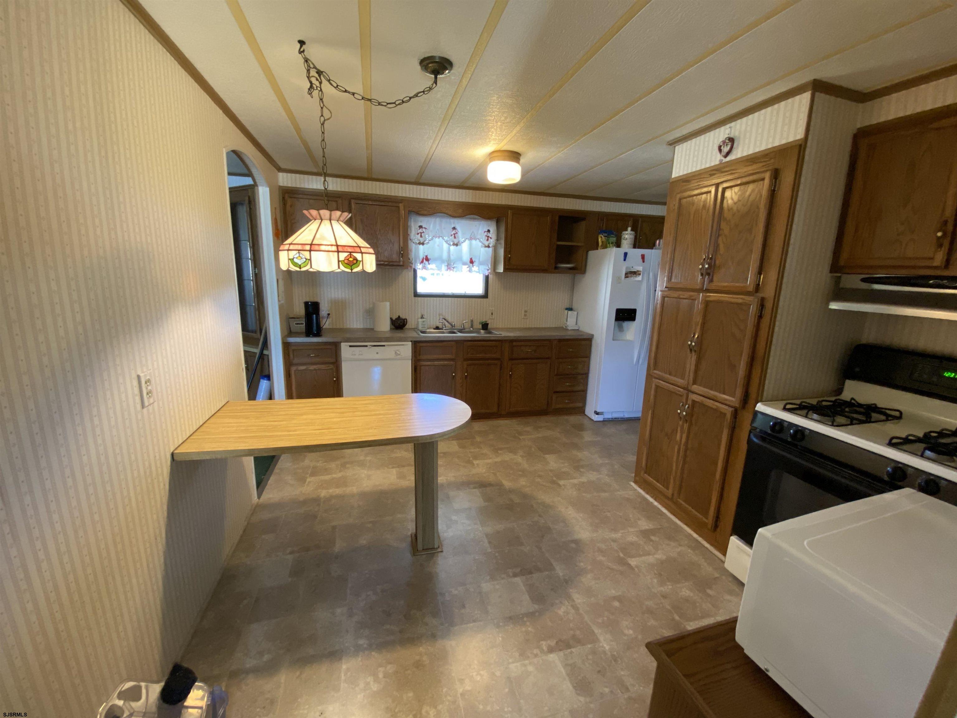 346 Puritan Drive Buena, NJ 08310 - Photo 14 of 22 a kitchen with stainless steel appliances granite countertop a refrigerator a sink a stove and a refrigerator