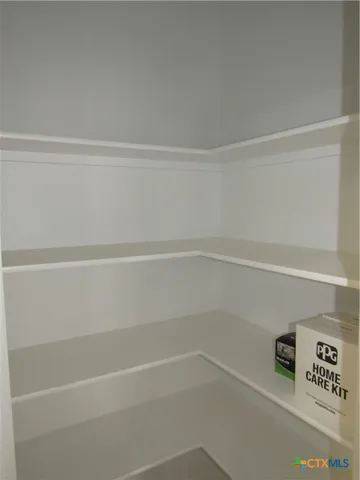 a view of a closet with wooden floor