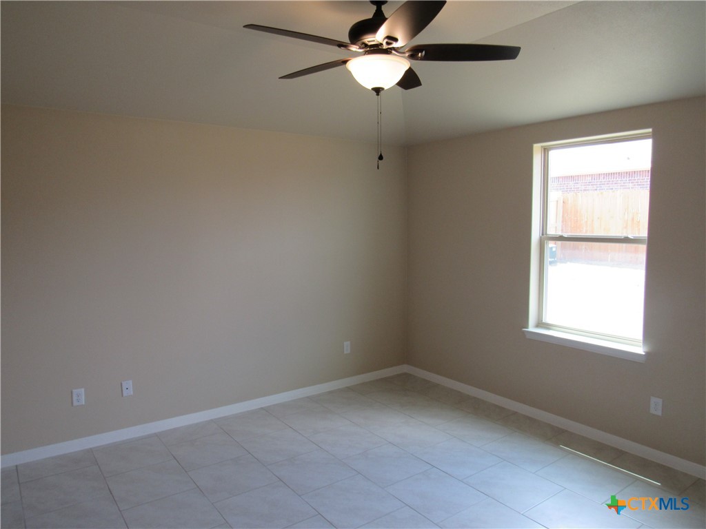 1108 Stealth Lane, Unit A Killeen, TX 76549 - Photo 9 of 21 an empty room with a window and a fan