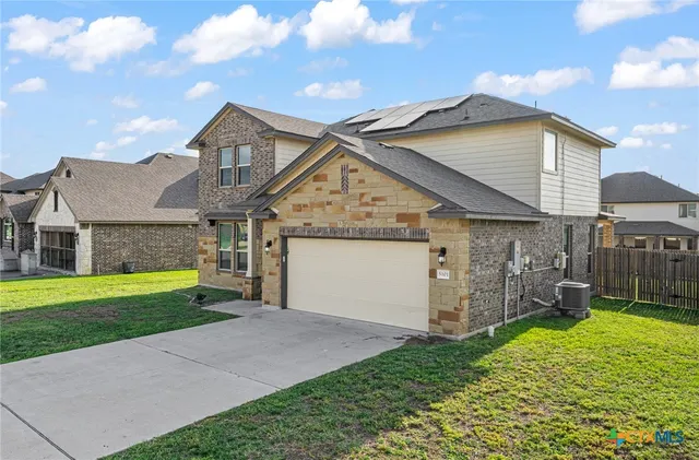 a view of a house with a yard and garage