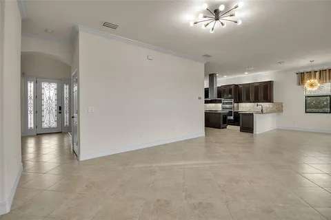 a kitchen with granite countertop a stove top oven and cabinets