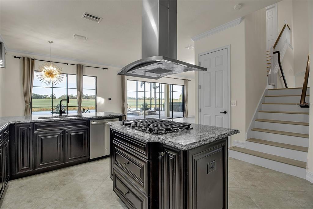 5609 Arnie Loop Lakewood Ranch, FL 34211 - Photo 19 of 64 a kitchen with stainless steel appliances granite countertop a stove a sink and a refrigerator