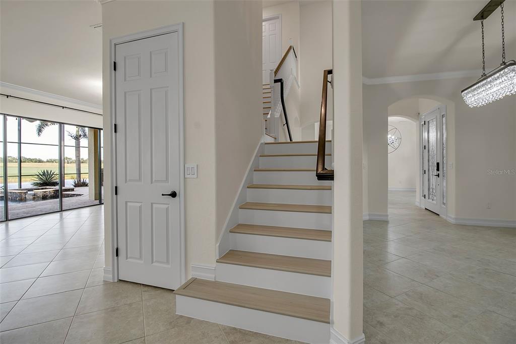 5609 Arnie Loop Lakewood Ranch, FL 34211 - Photo 25 of 64 a view of a hallway with wooden floor and entryway