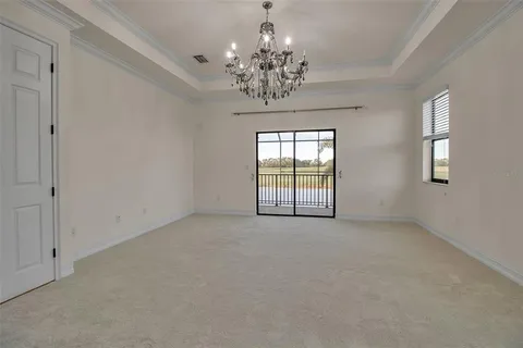 an empty room that has a chandelier and chandelier in it