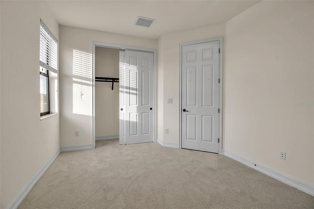 5609 Arnie Loop Lakewood Ranch, FL 34211 - Photo 38 of 64 wooden floor and windows in an empty room