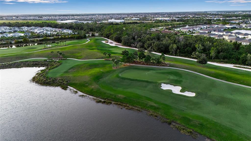 5609 Arnie Loop Lakewood Ranch, FL 34211 - Photo 59 of 64 an aerial view of a golf course with parking space