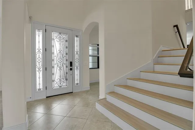 a view of a hallway with wooden floor and entryway