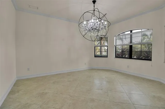 a view of an empty room with a chandelier