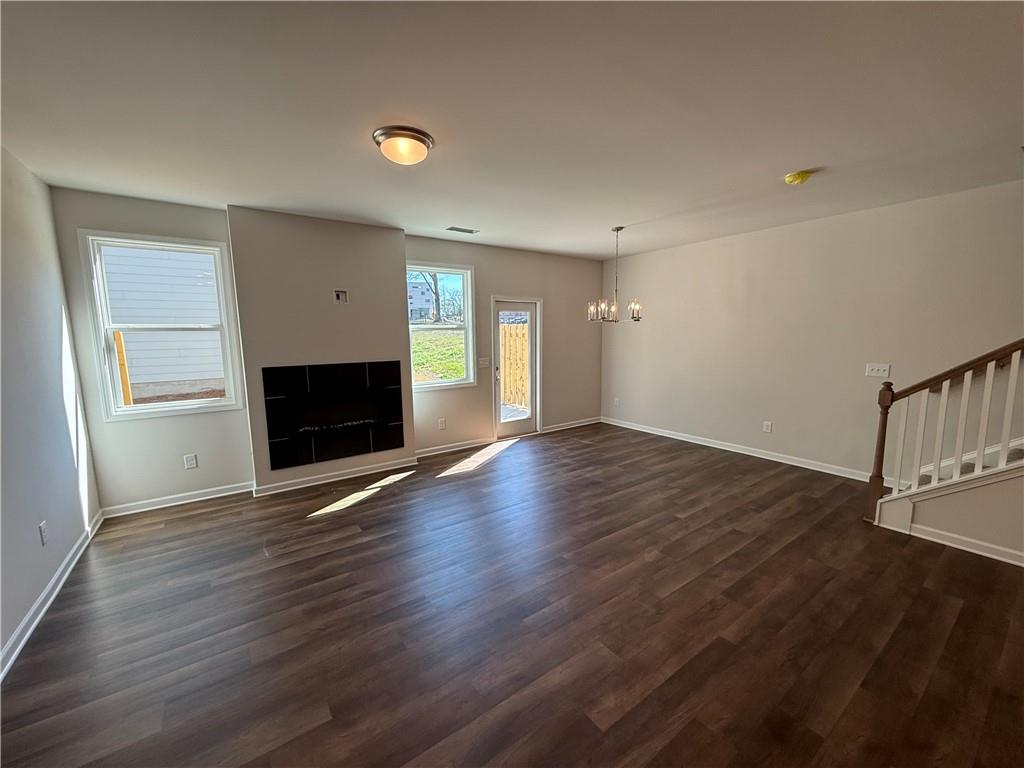5143 Longview Run Decatur, GA 30035 - Photo 2 of 17 an empty room with wooden floor fireplace and windows