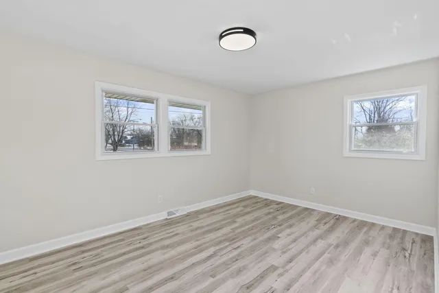 a view of room with window and wooden floor