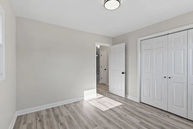 a view of an empty room and wooden floor