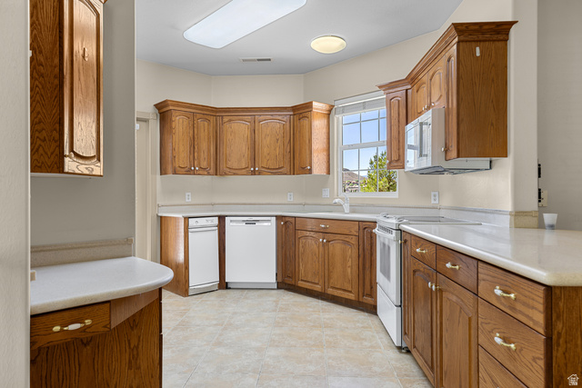 389 North Main Street St. George, UT 84770 - Photo 23 of 44 Kitchen with white appliances, light countertops, and wood finish cabinets