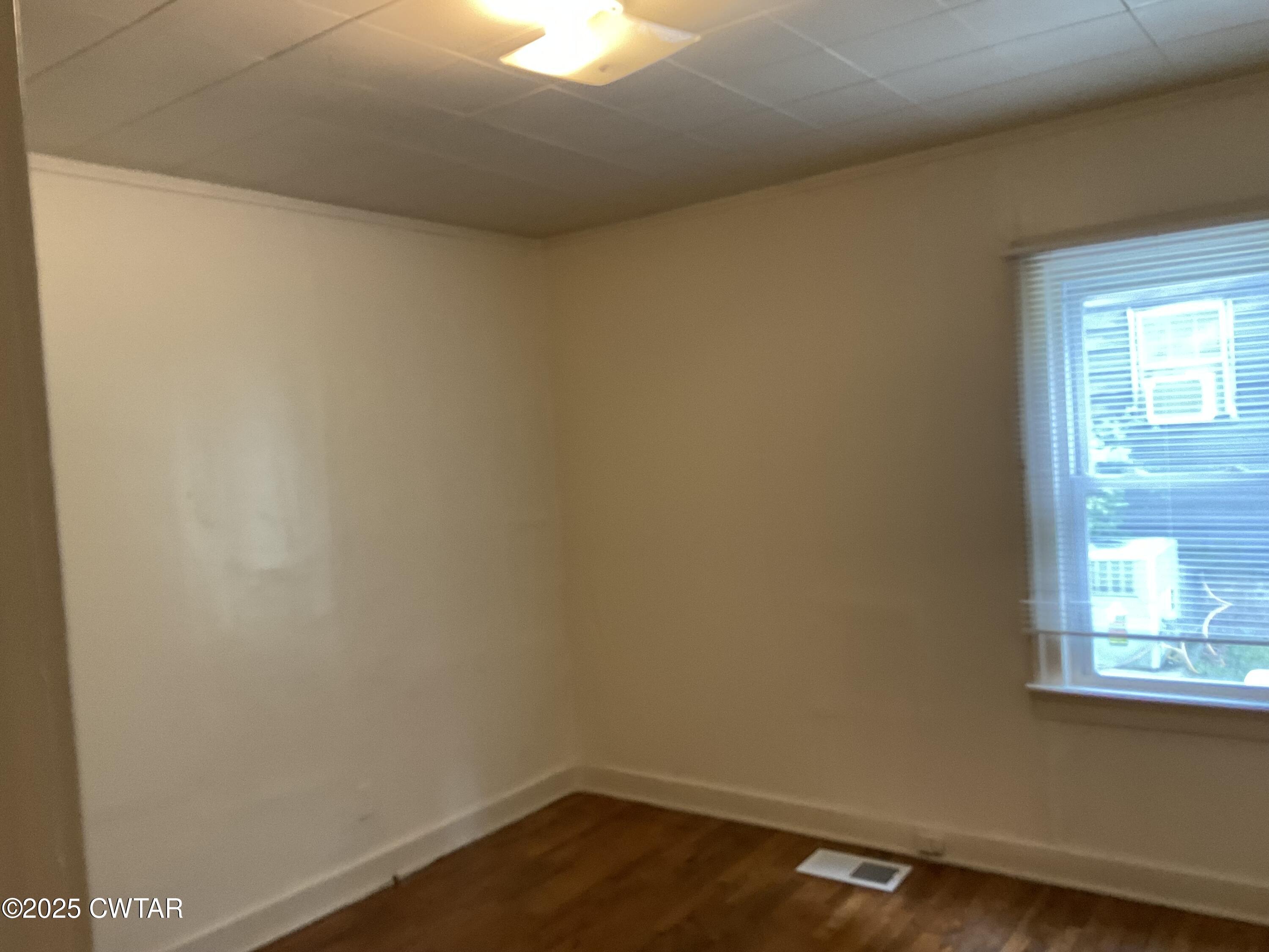124 Muse Street Jackson, TN 38301 - Photo 14 of 14 a view of a small space with wooden floor and a window