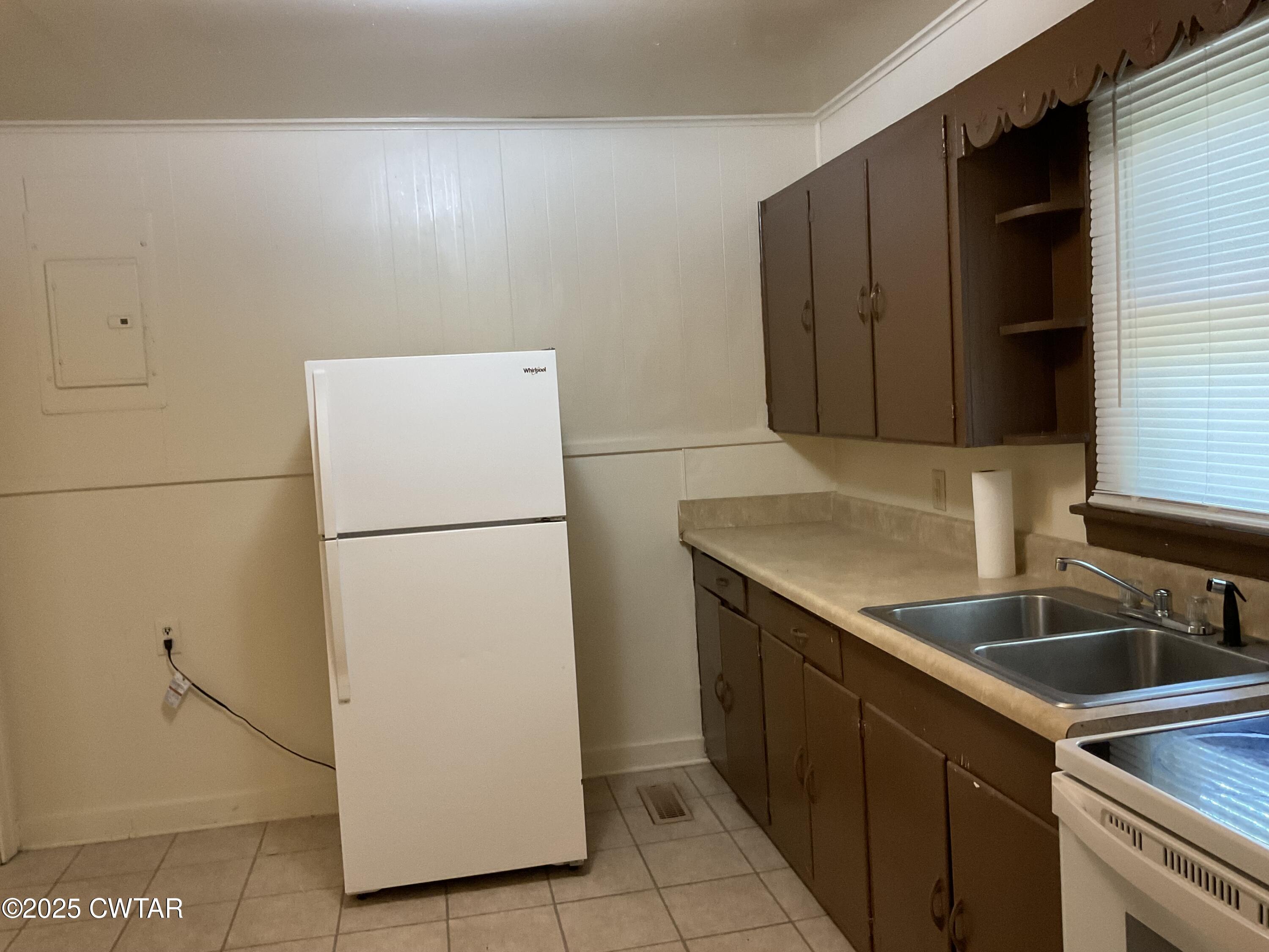 124 Muse Street Jackson, TN 38301 - Photo 3 of 14 a kitchen with a refrigerator and a sink