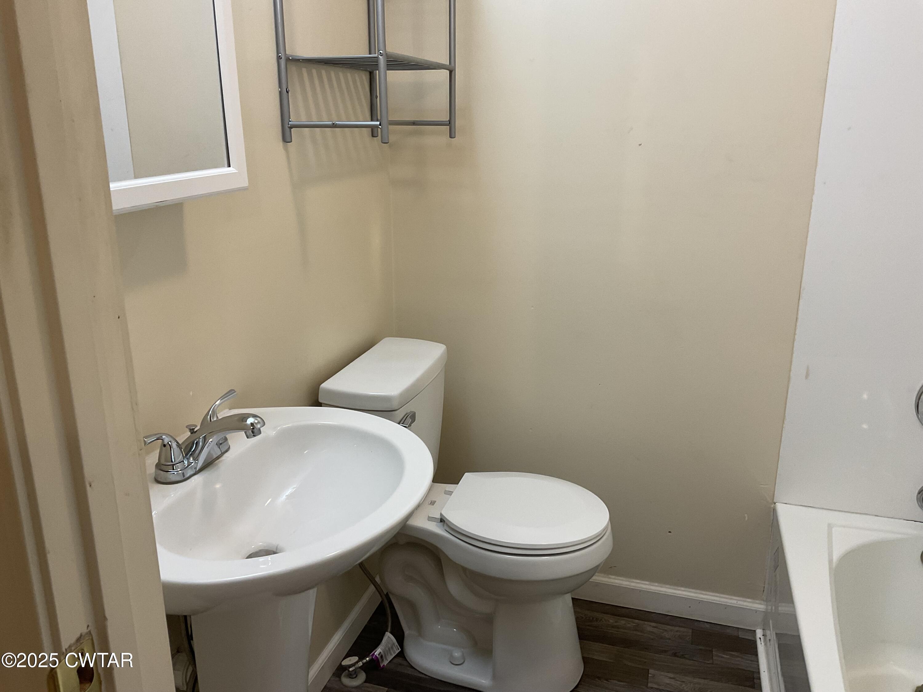 124 Muse Street Jackson, TN 38301 - Photo 7 of 14 a bathroom with a sink a toilet and a mirror