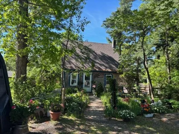 front view of a house with a tree