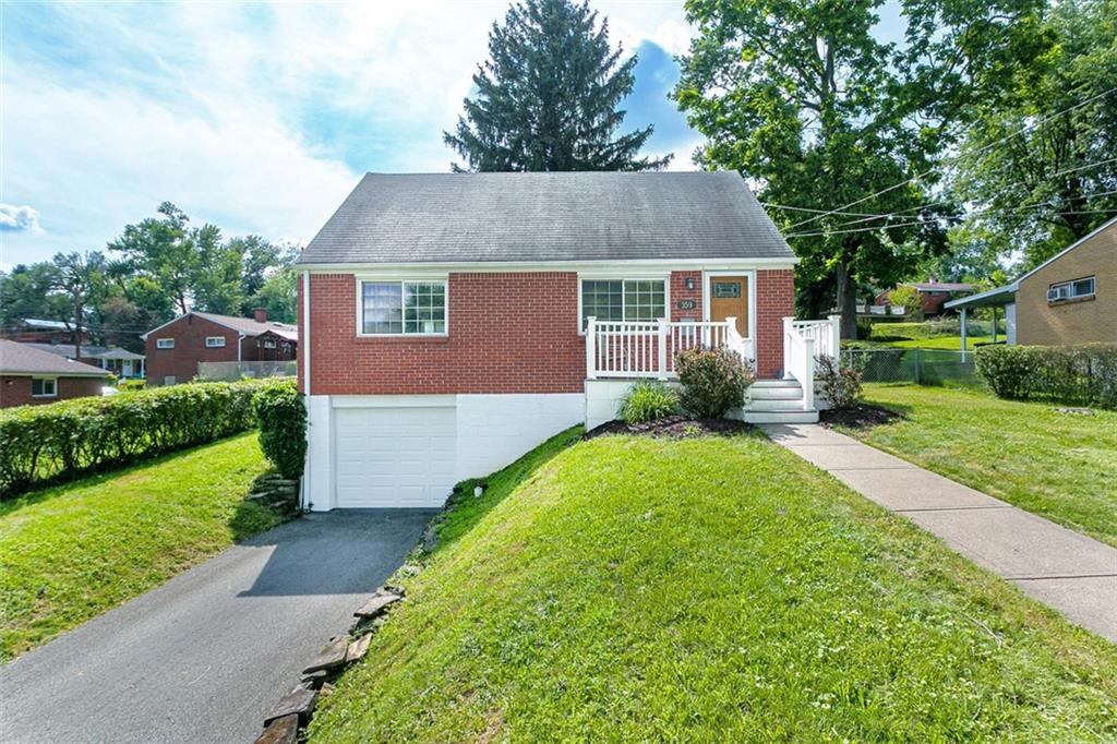 a aerial view of a house with yard and green space