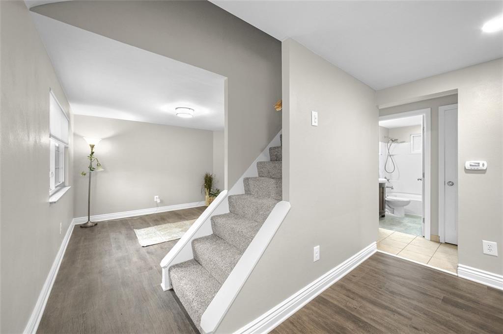 359 Hochberg Road Monroeville, PA 15146 - Photo 11 of 30 a view of an empty room with wooden floor and a bathroom
