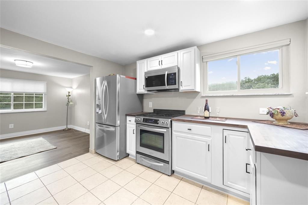 359 Hochberg Road Monroeville, PA 15146 - Photo 17 of 30 a kitchen with stainless steel appliances granite countertop a stove a sink and a microwave