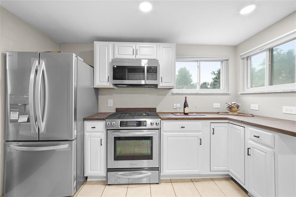 359 Hochberg Road Monroeville, PA 15146 - Photo 19 of 30 a kitchen with white cabinets and stainless steel appliances