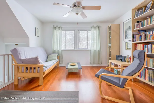 a living room with furniture a bookshelf and a bookshelf