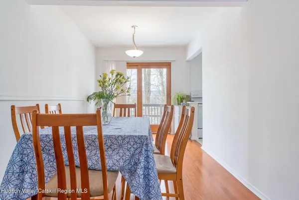 a view of a dining room with furniture window and wooden floor