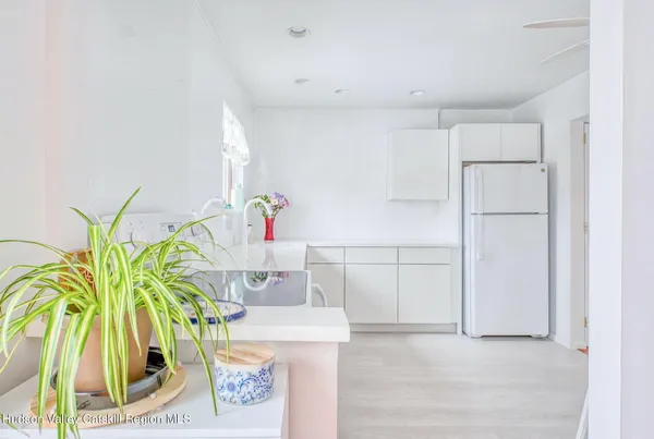 a kitchen with white cabinets and counter space