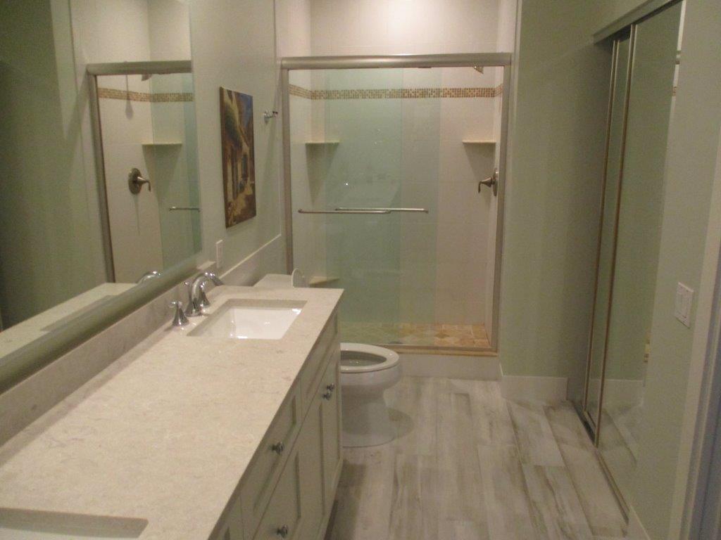 57 Laurel Oaks Circle Tequesta, FL 33469 - Photo 11 of 18 a bathroom with a sink a toilet and shower