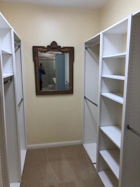 57 Laurel Oaks Circle Tequesta, FL 33469 - Photo 15 of 18 a view of walk in closet with empty racks
