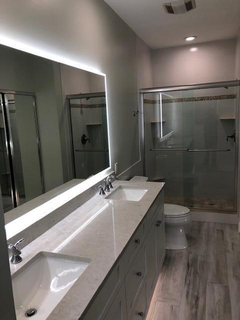 57 Laurel Oaks Circle Tequesta, FL 33469 - Photo 18 of 18 a bathroom with a sink a toilet and shower