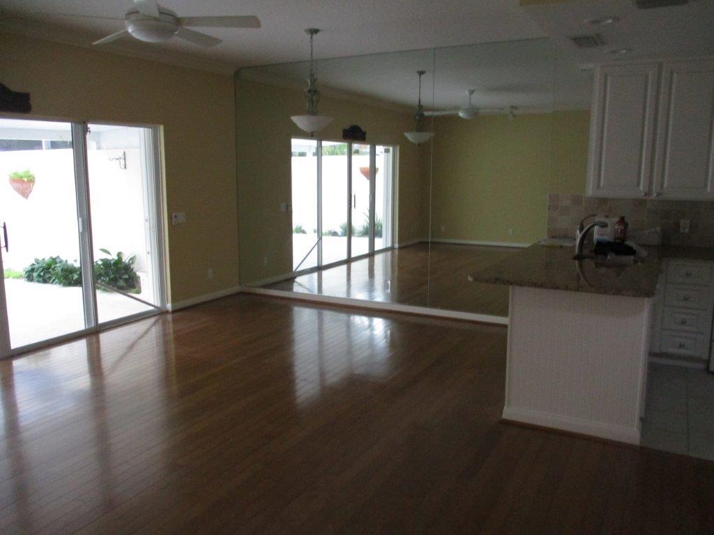 57 Laurel Oaks Circle Tequesta, FL 33469 - Photo 3 of 18 a kitchen with granite countertop a stove and a wooden floors