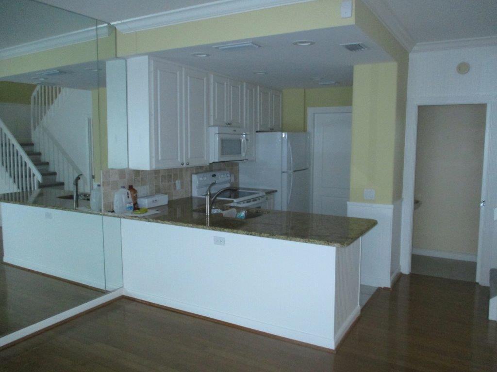 57 Laurel Oaks Circle Tequesta, FL 33469 - Photo 4 of 18 a kitchen with granite countertop a sink and a refrigerator
