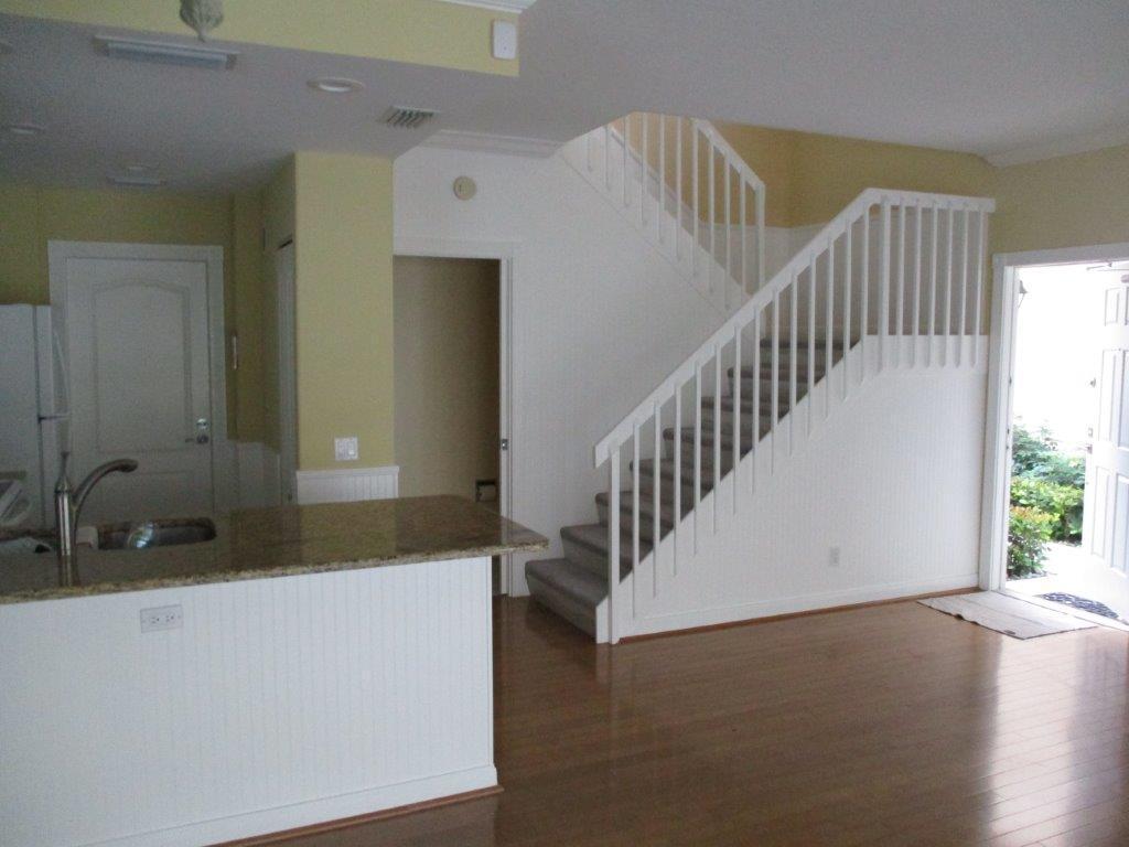 57 Laurel Oaks Circle Tequesta, FL 33469 - Photo 5 of 18 a view of staircase and hall with wooden floor