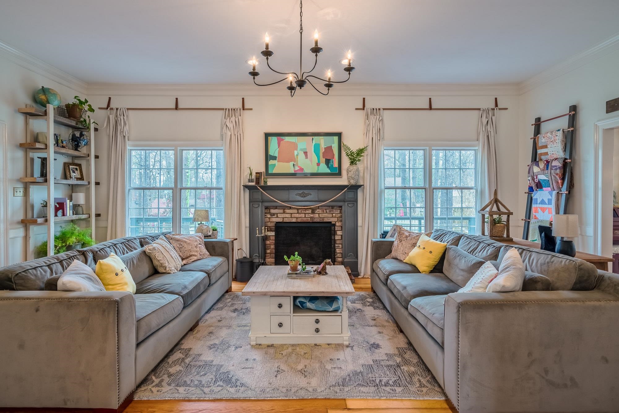 810 West Tree Cove Collierville, TN 38017 - Photo 5 of 25 a living room with furniture a fireplace and a chandelier