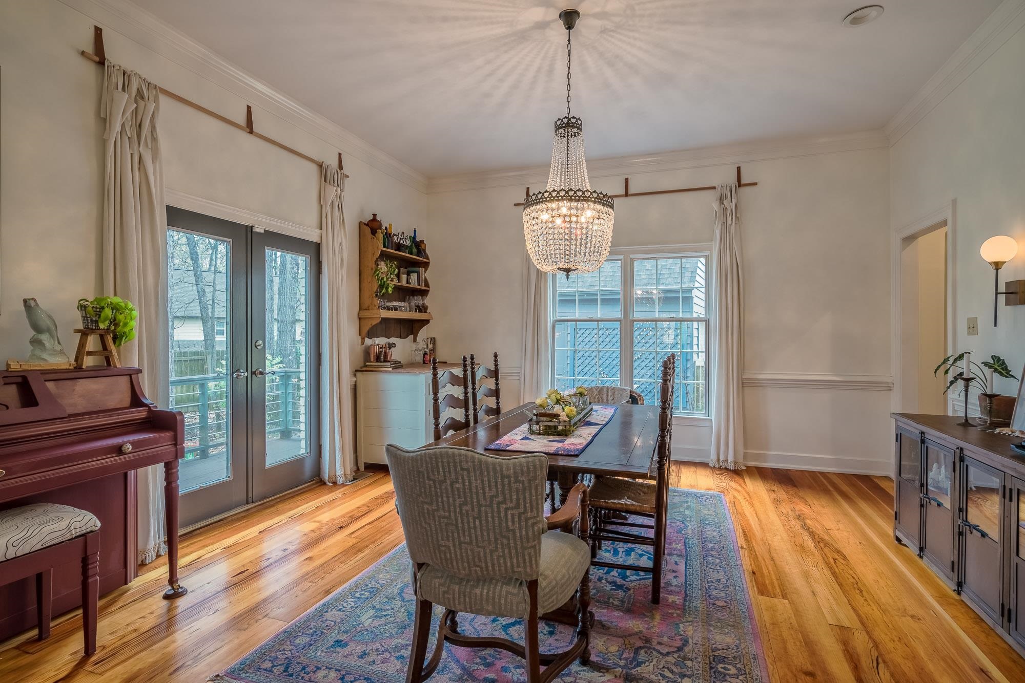 810 West Tree Cove Collierville, TN 38017 - Photo 8 of 25 a view of a dining room with furniture a chandelier and wooden floor